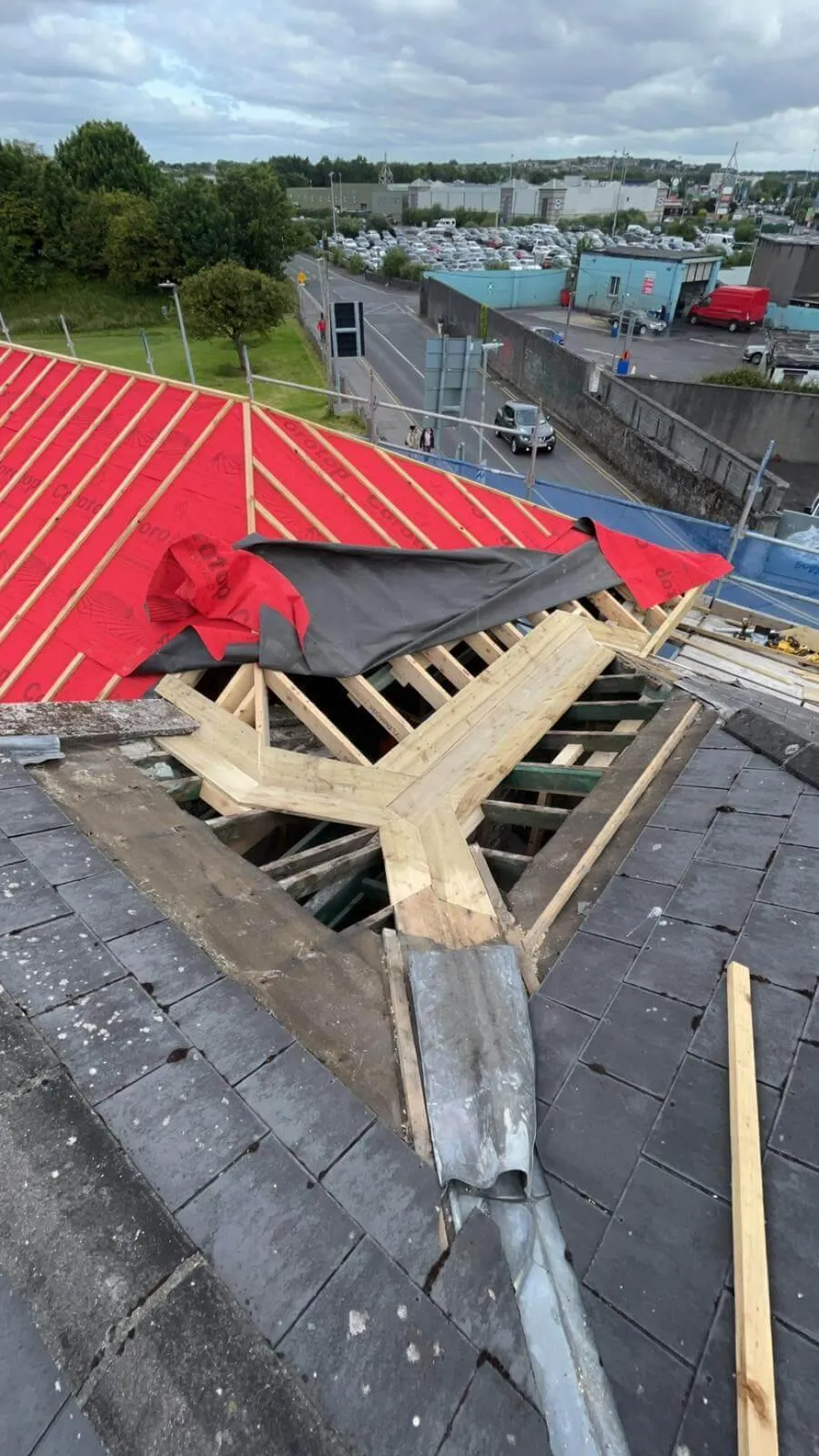 Roofer working on red tile roof
