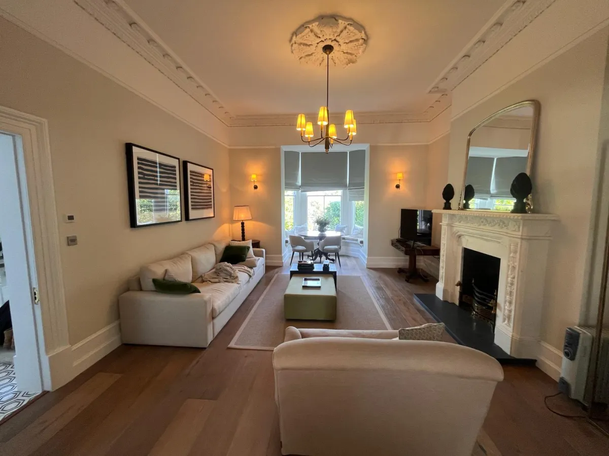 Living room renovation with fireplace and garden view