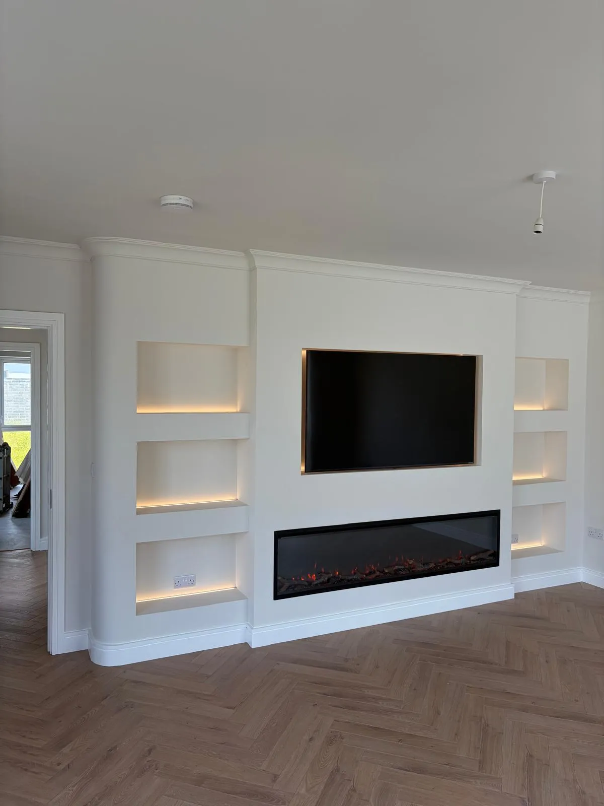 Built-in media wall with floating shelves and TV unit